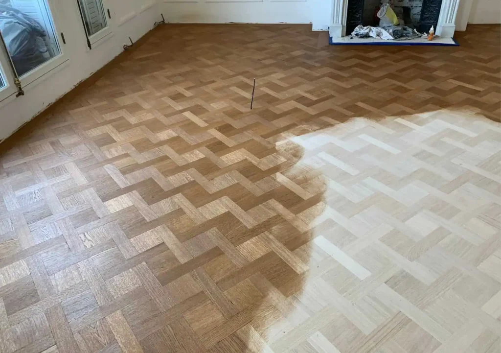 Herringbone parquet flooring with restoration and refinishing in progress