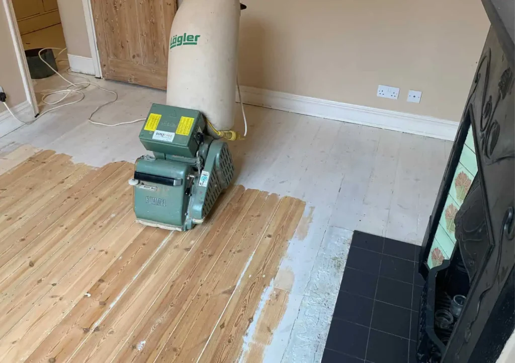 Industrial floor sanding machine in residential room under renovation