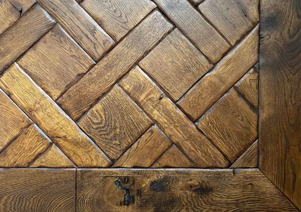 Herringbone wooden parquet flooring pattern with border