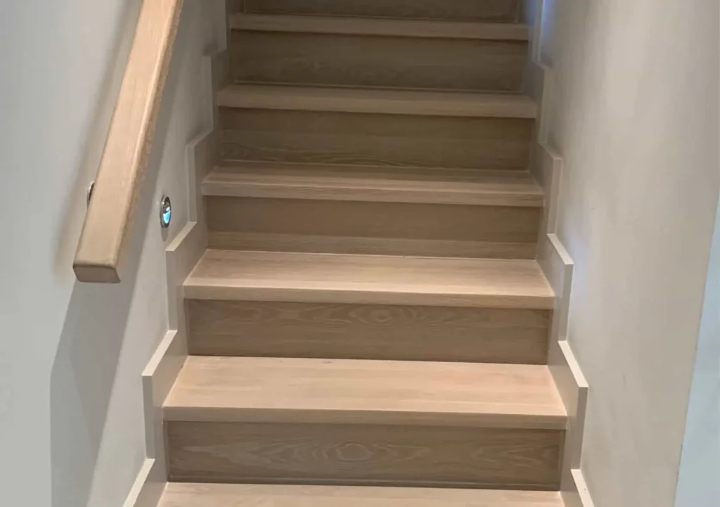 Wooden staircase with light wood treads and darker risers