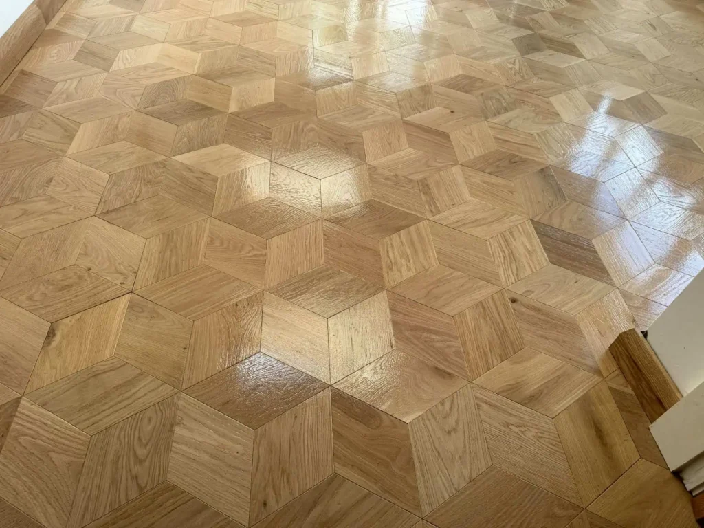 Polished wooden parquet floor with 3D hexagonal tile pattern