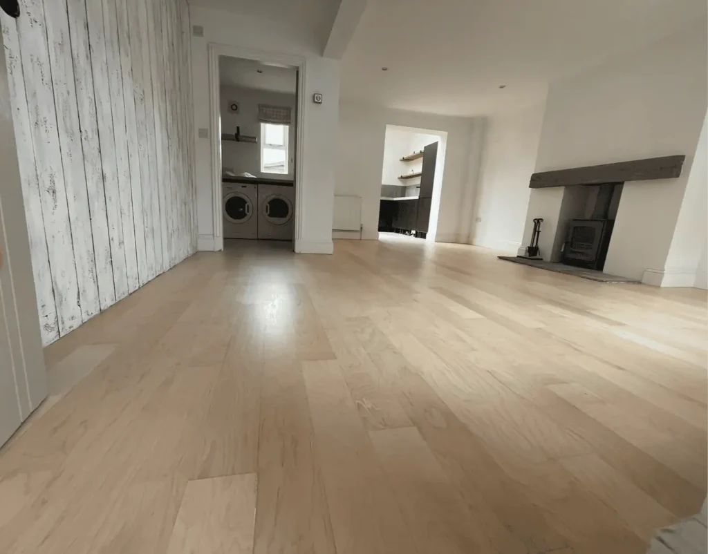 Modern open-plan living room with wooden flooring and fireplace
