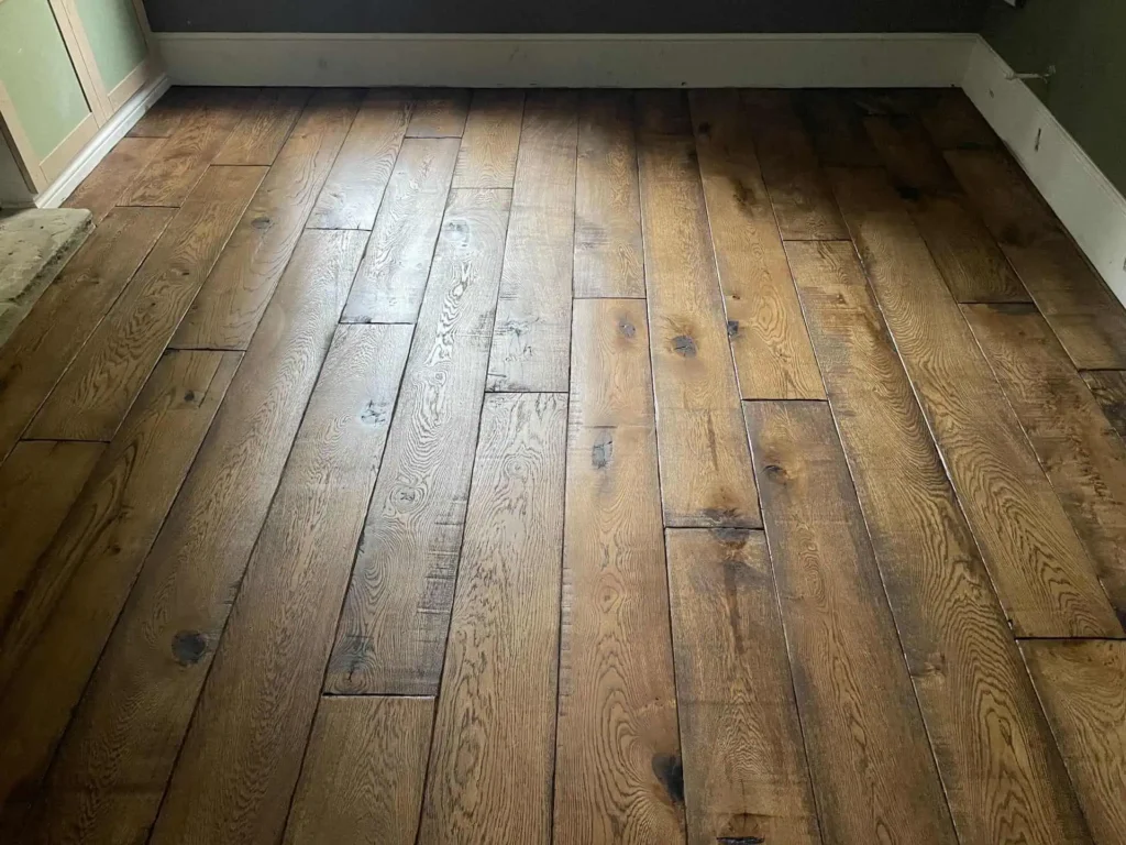 Wooden hardwood floor with random plank pattern and knots