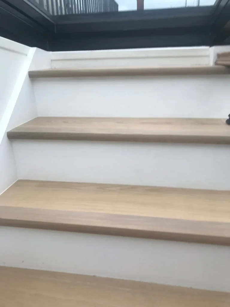 Modern staircase with wooden treads and white risers