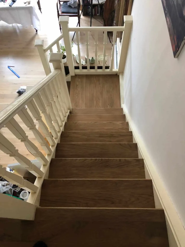 Wooden staircase with cream painted balustrade and spindles