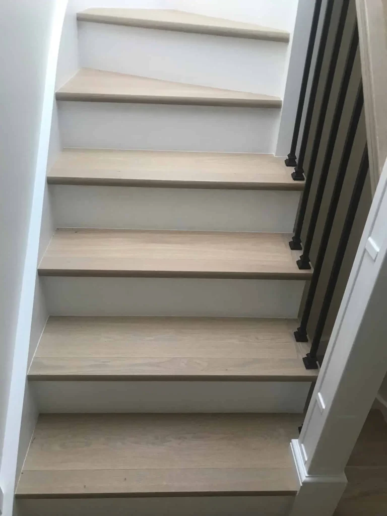 Modern staircase with wooden treads and grey striped railing
