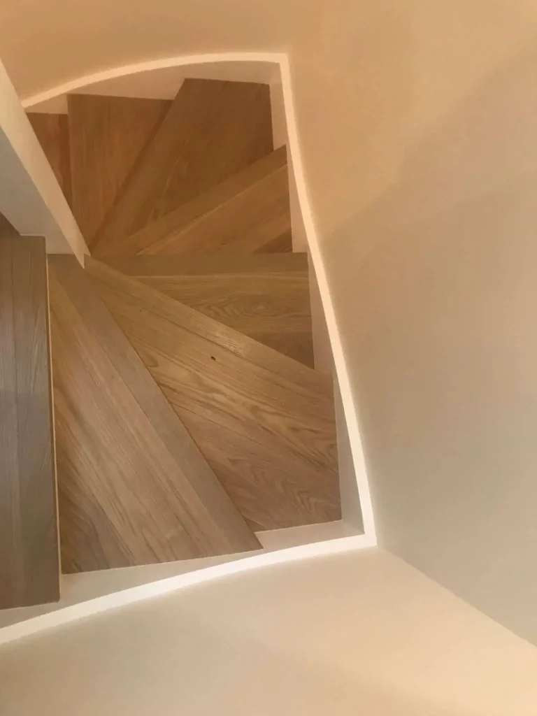 Modern wooden staircase descending in contemporary building interior