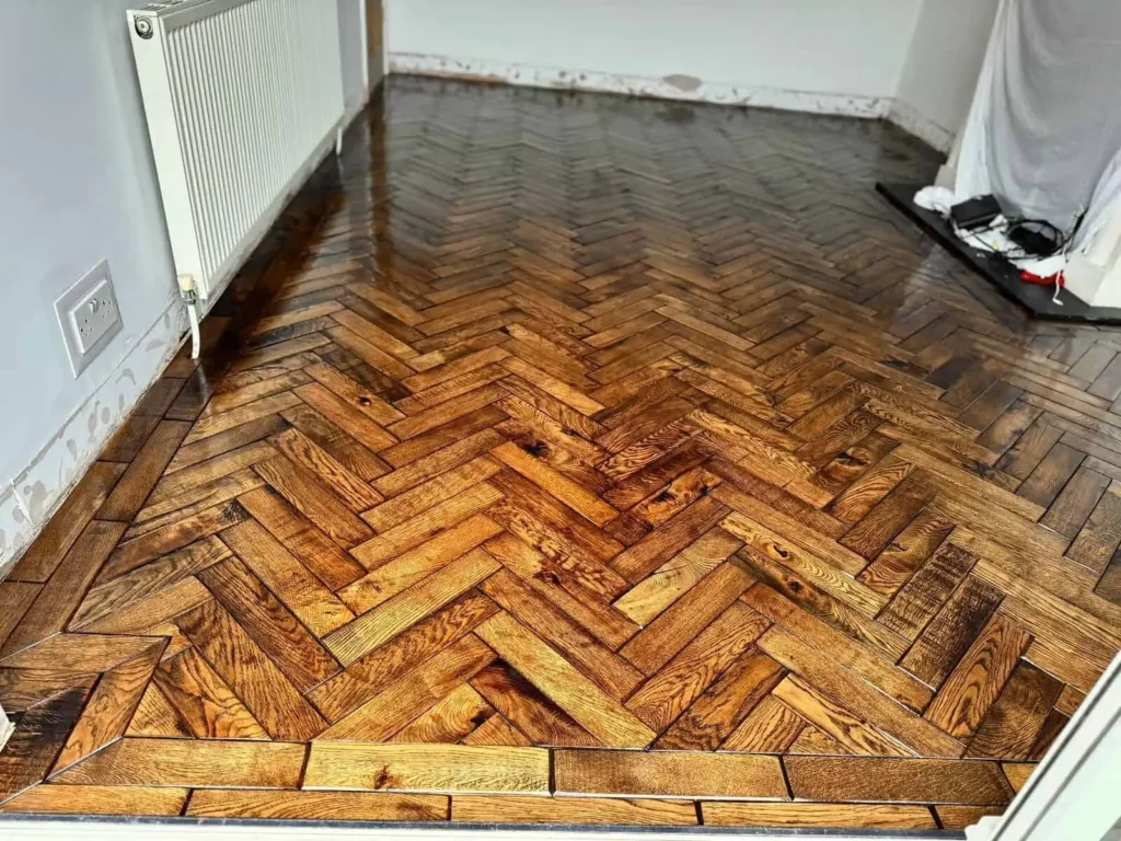 Herringbone parquet wooden floor in empty room