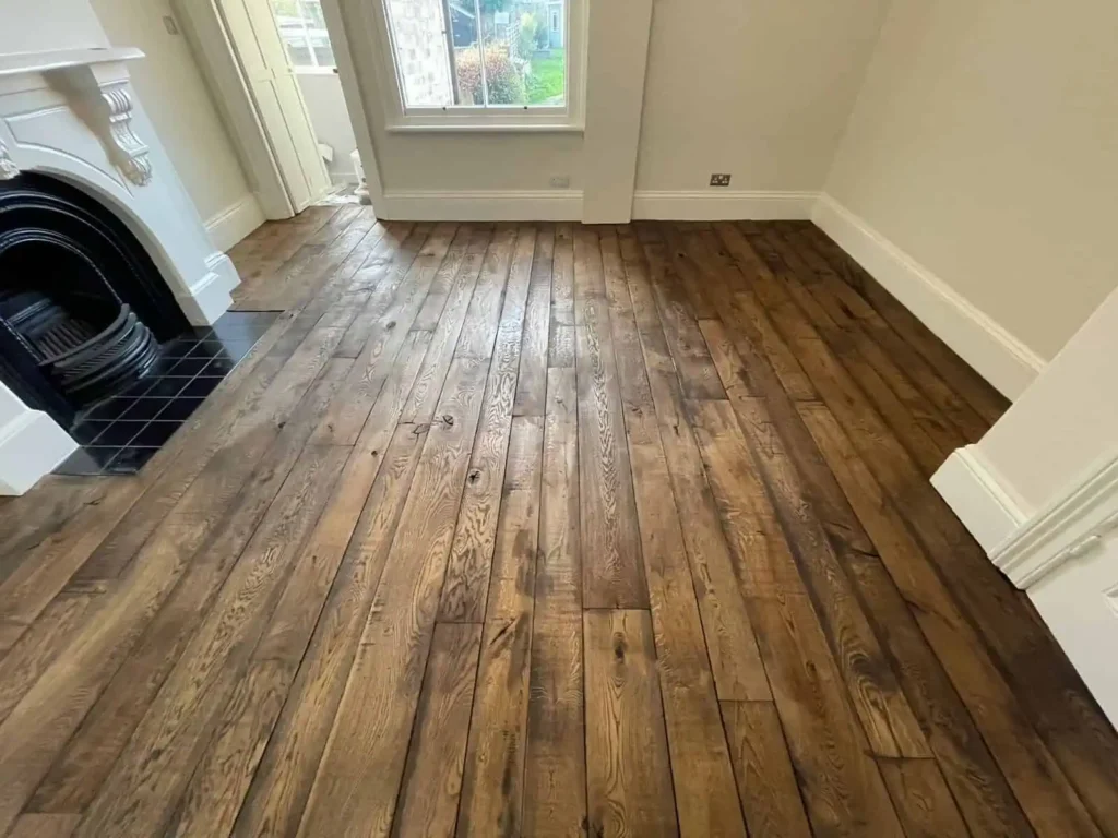 Modern living room with dark wood flooring and cream walls