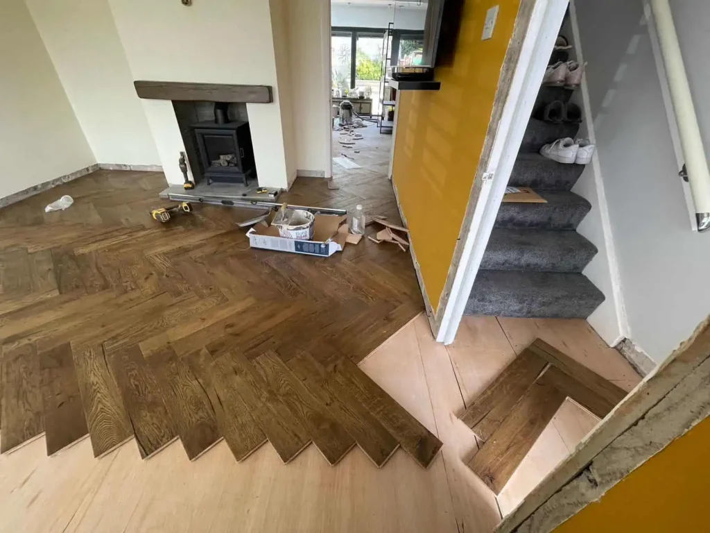 Home interior renovation with wood flooring and staircase installation