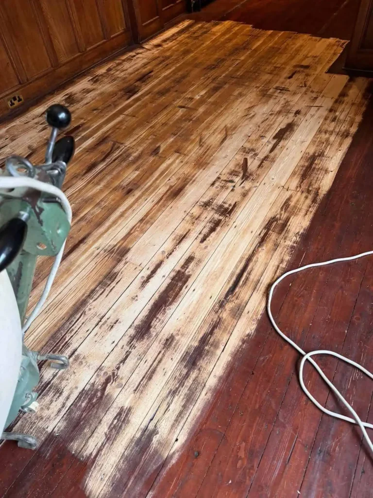 Wooden floor being cleaned with professional cleaning machine