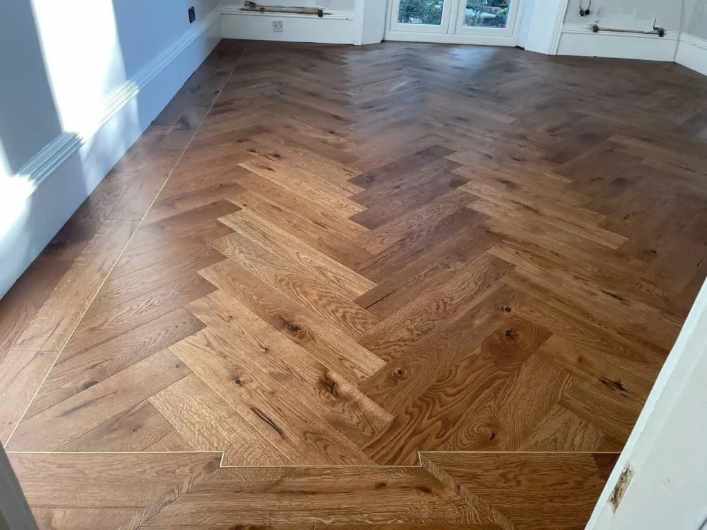 Herringbone pattern wooden flooring in bright living room