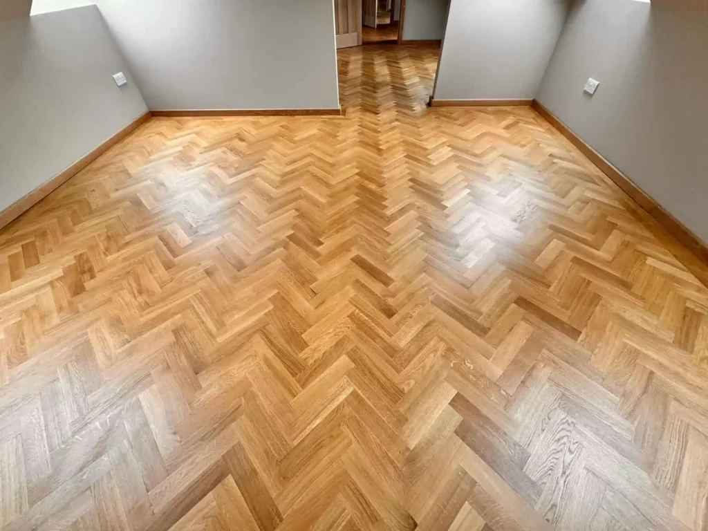 Empty room with herringbone parquet wood flooring