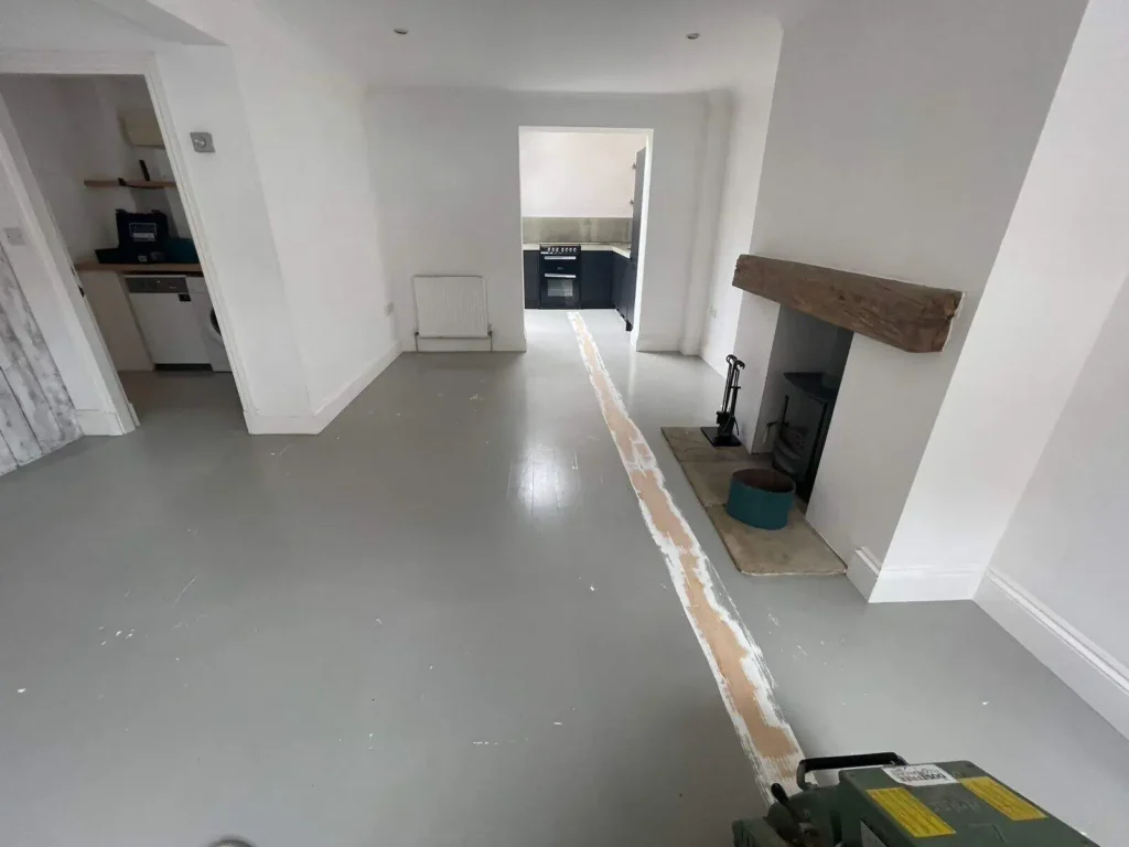 Empty residential interior with concrete floor and white walls