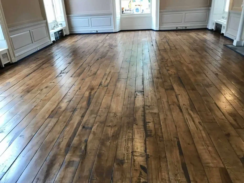 Empty room with wooden hardwood flooring and white panelled doors