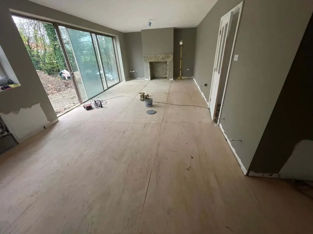Empty modern living room under construction with wooden flooring