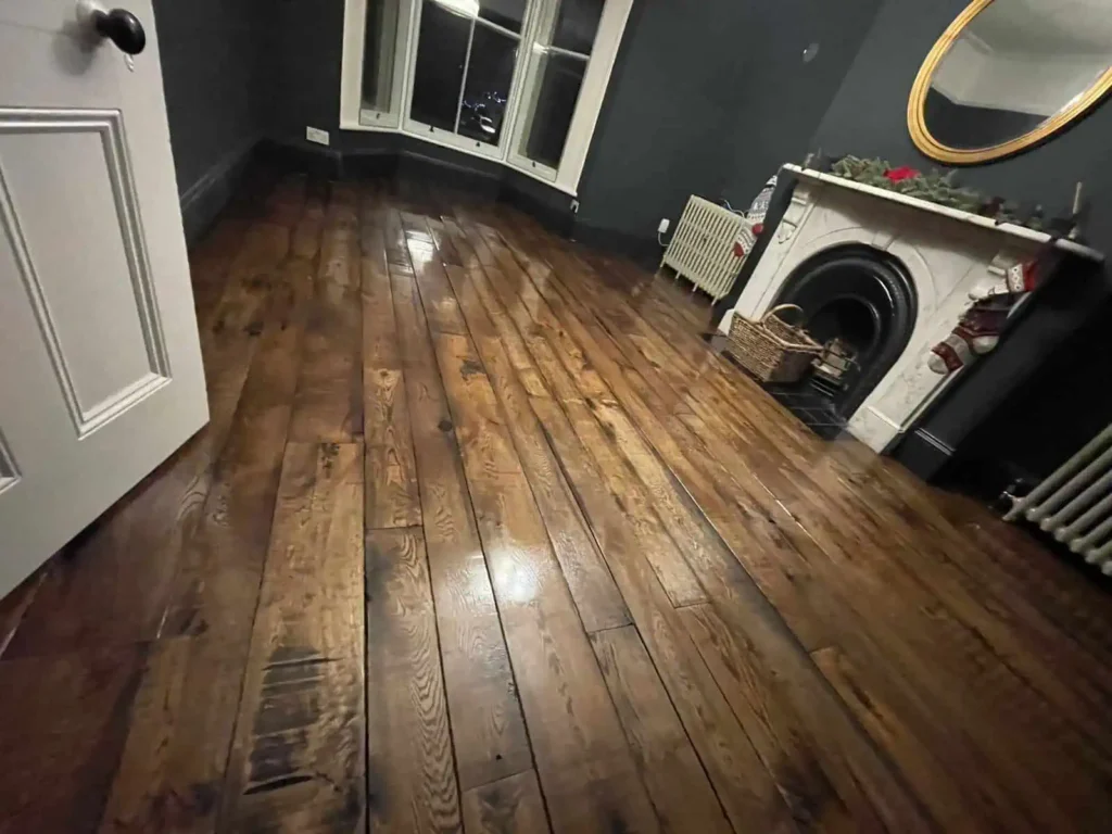 Modern laundry room with dark grey walls and wooden flooring
