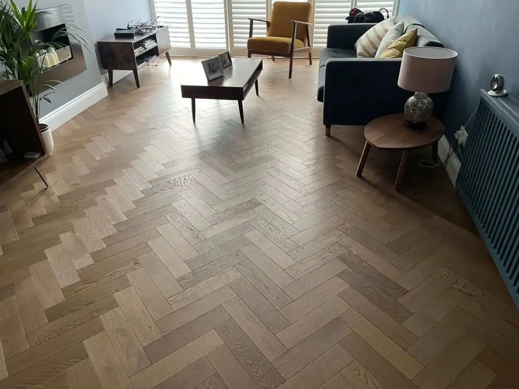 Modern living room with herringbone wood flooring and mid-century furniture