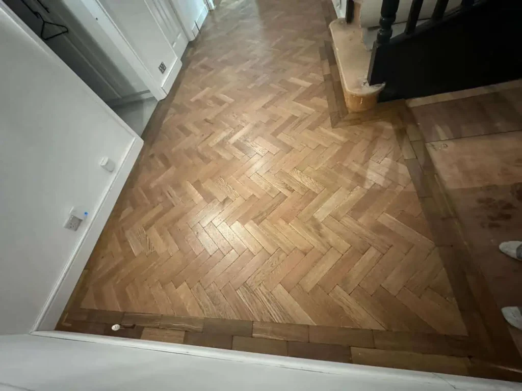 Herringbone parquet wooden floor in modern hallway