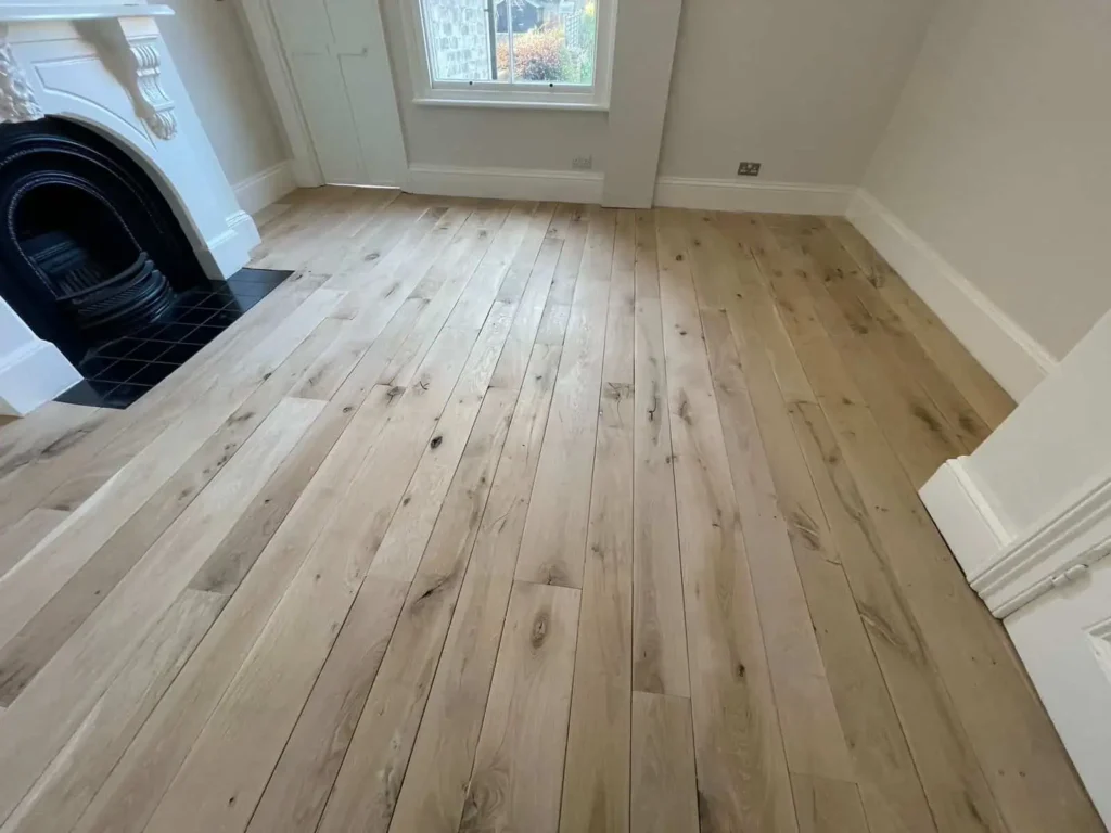 Empty room with newly installed light wood plank flooring