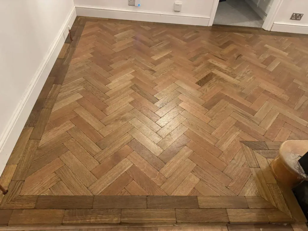 Herringbone pattern wooden flooring in residential room