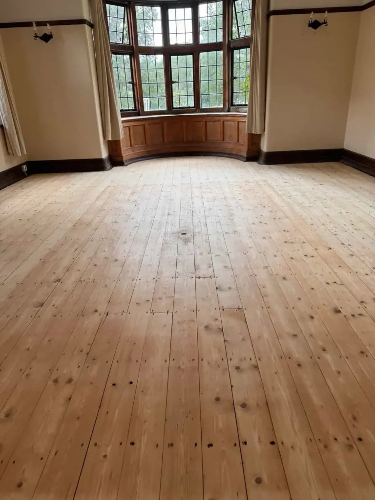 Empty room with wooden floors and bay windows