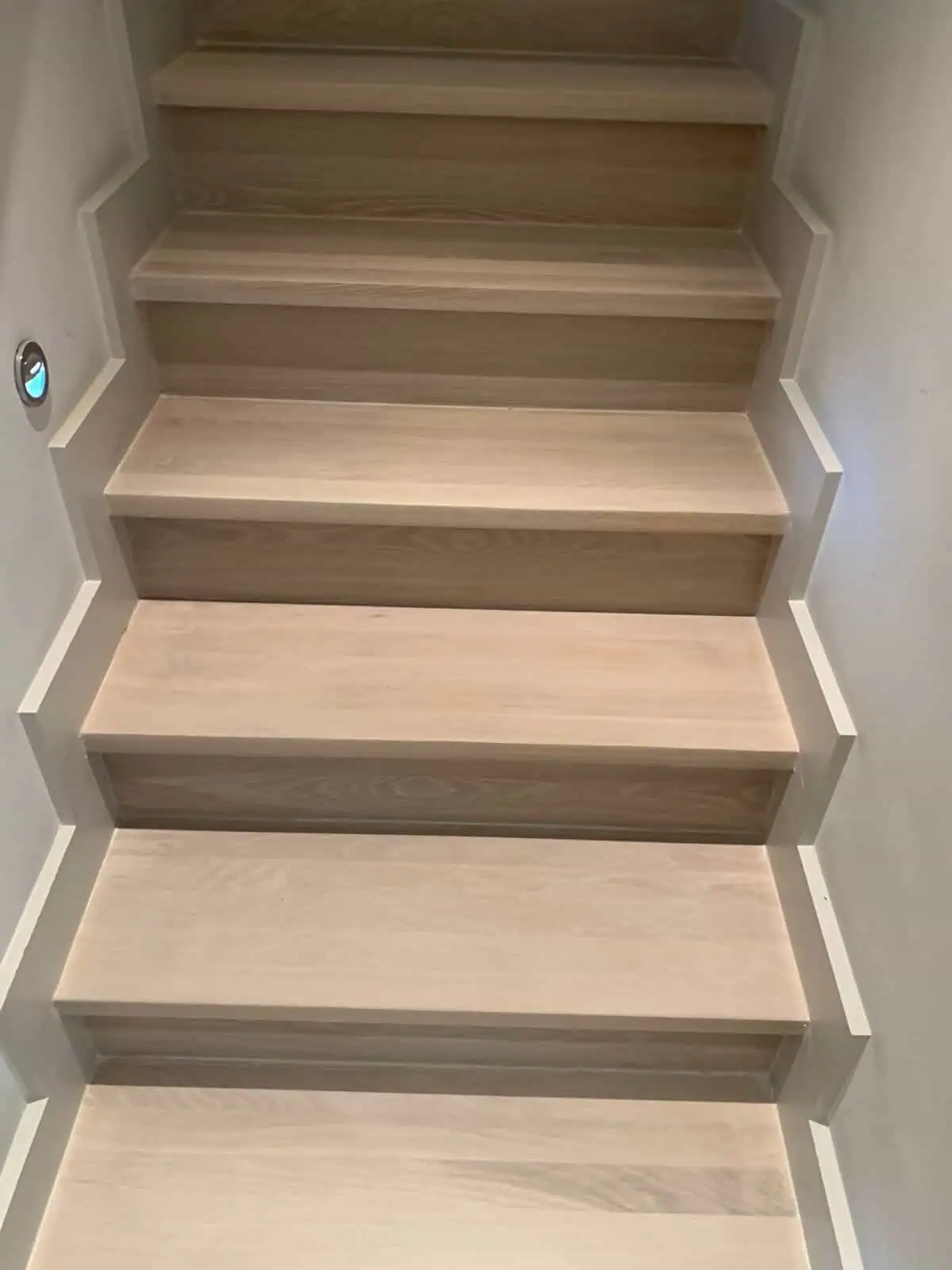 Wooden staircase with light treads and dark risers