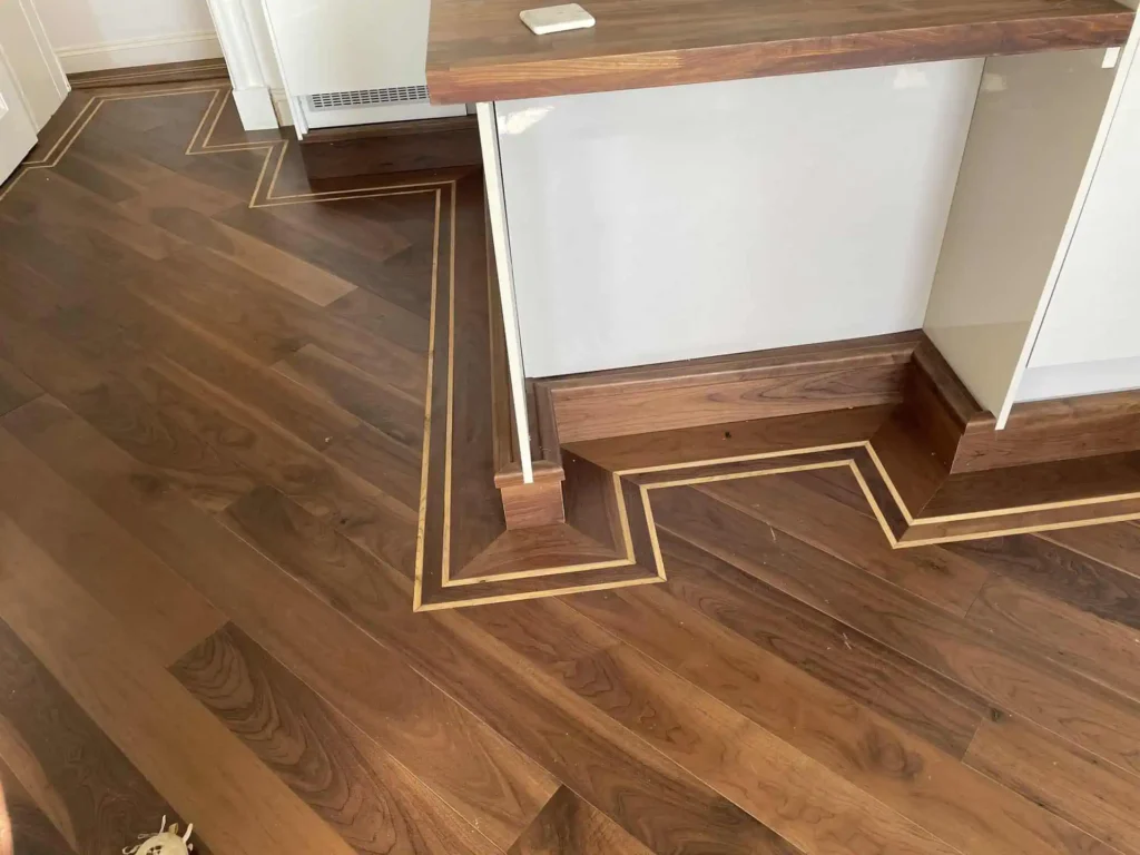 Luxury wooden flooring with inlaid border and modern reception desk