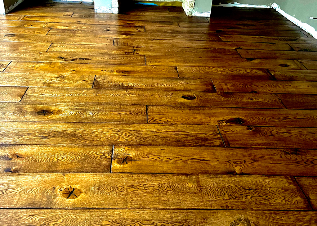 Golden oak hardwood flooring with natural knots and grain patterns