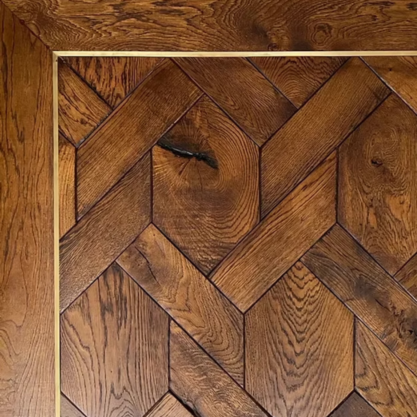Herringbone parquet wooden flooring with natural grain patterns