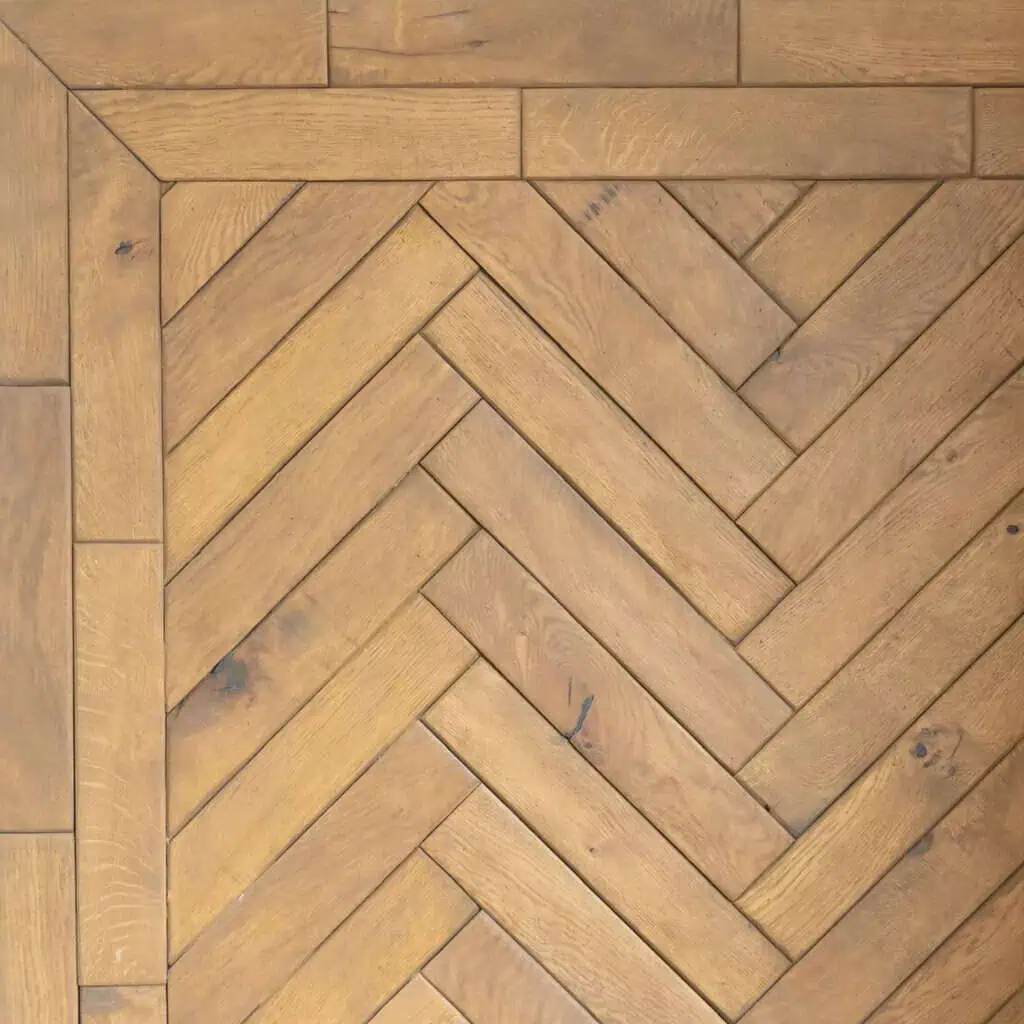 Herringbone parquet wooden flooring pattern with border