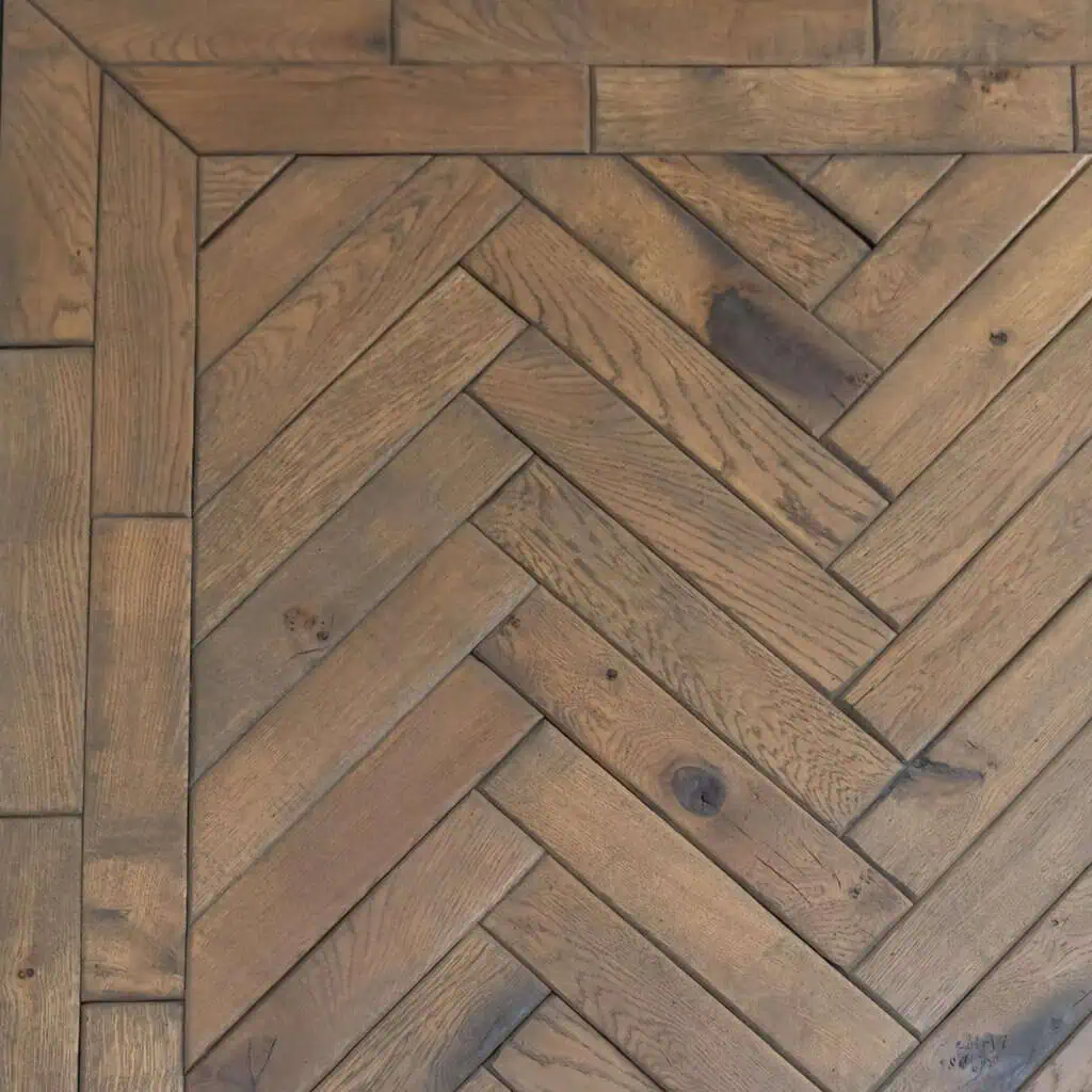 Brown herringbone pattern wooden floor close-up