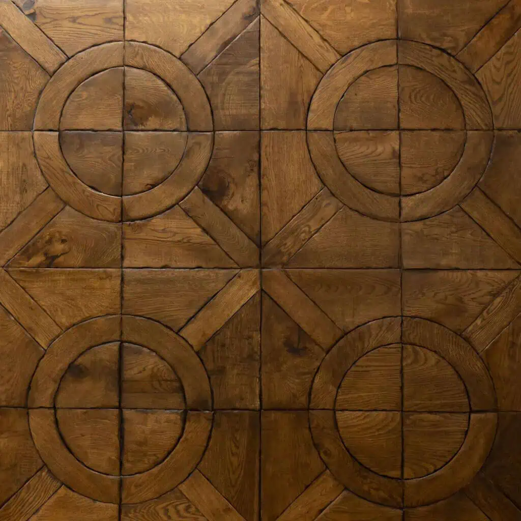 Geometric wooden parquet floor with circular and diamond patterns