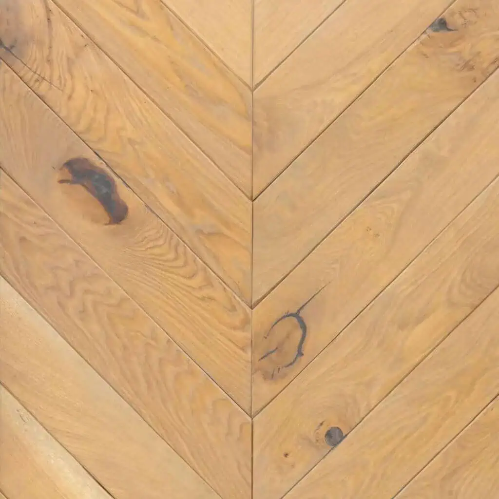Herringbone light wood flooring with natural knots and markings