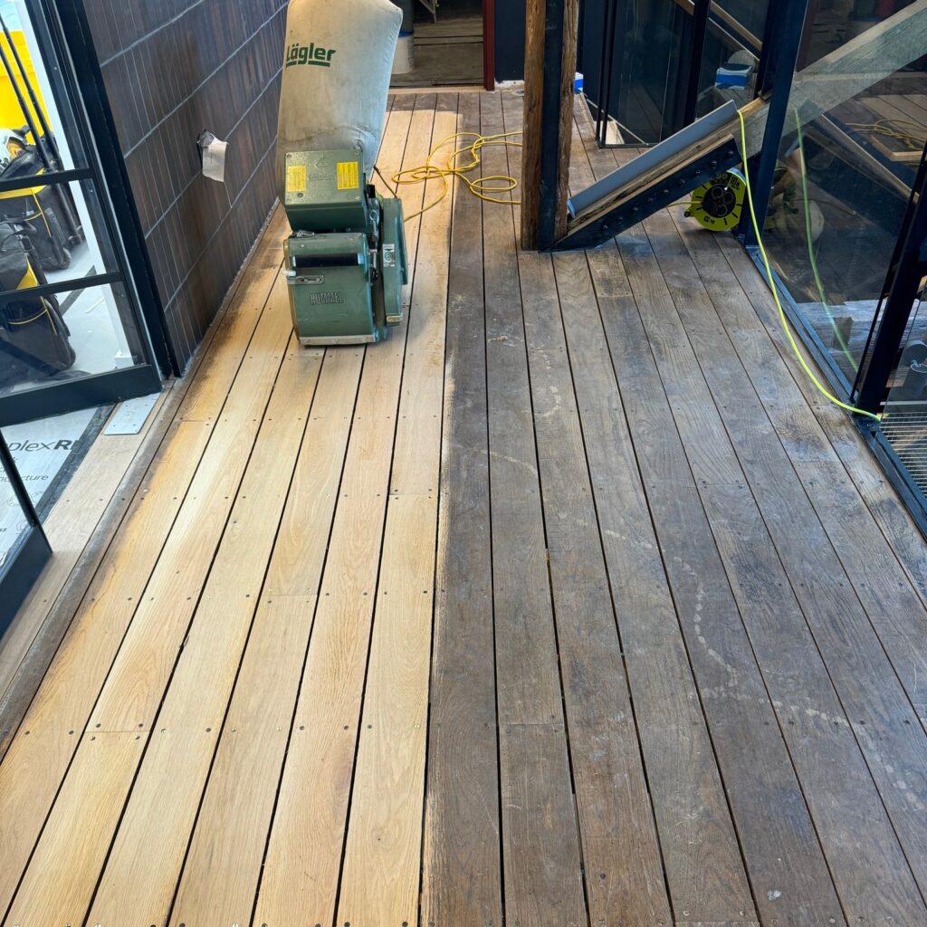 Wooden boat deck with cleaning equipment and machinery