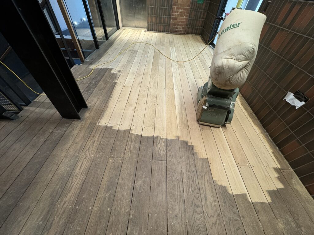 Wooden decking with cleaning equipment and power cable