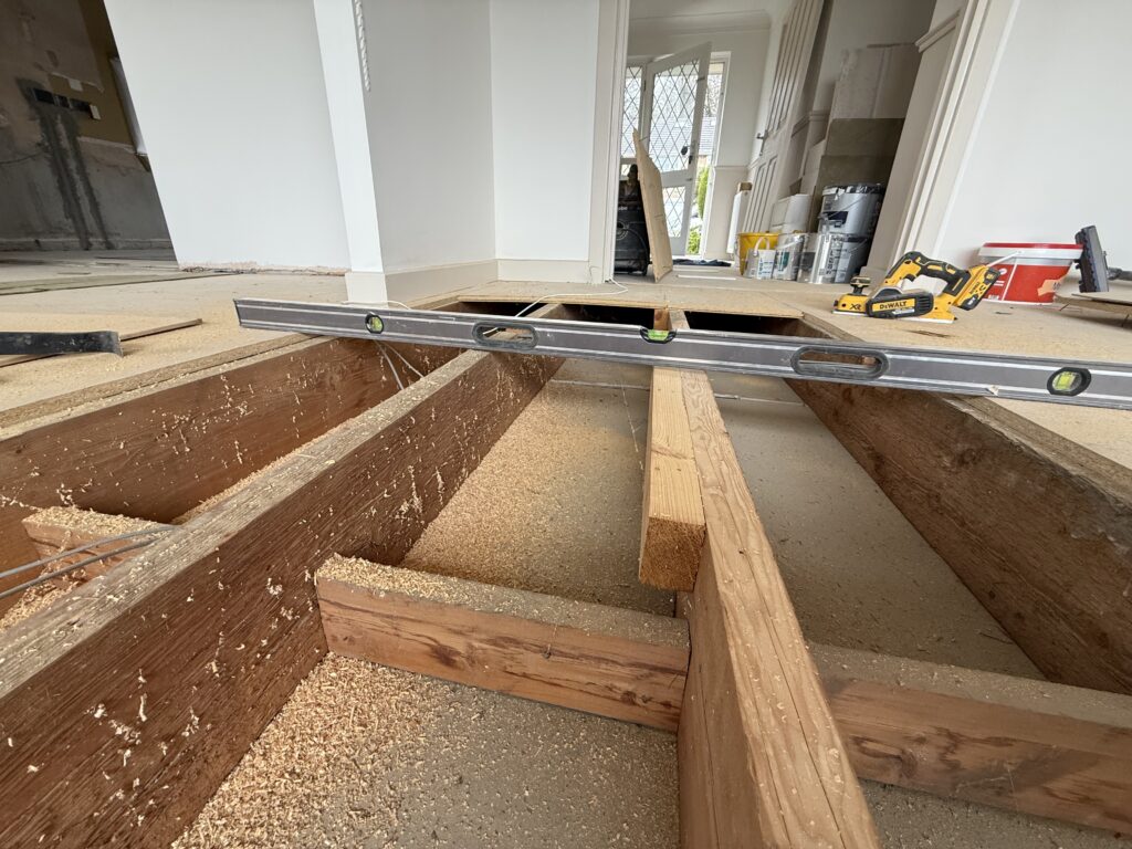 Kitchen renovation with wooden joists and spirit level tool