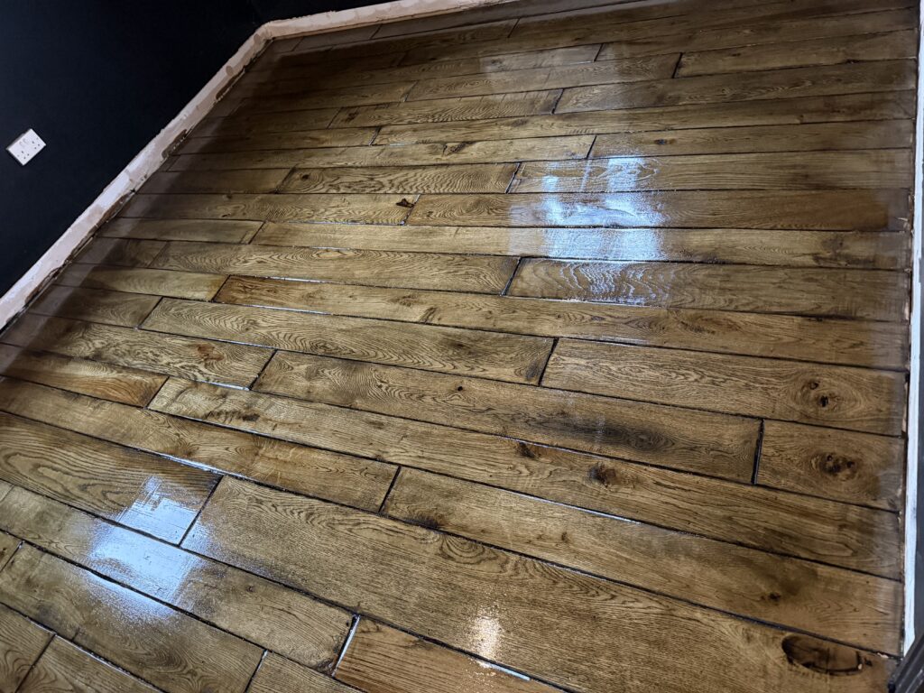 Wooden hardwood floor with random light blue patches