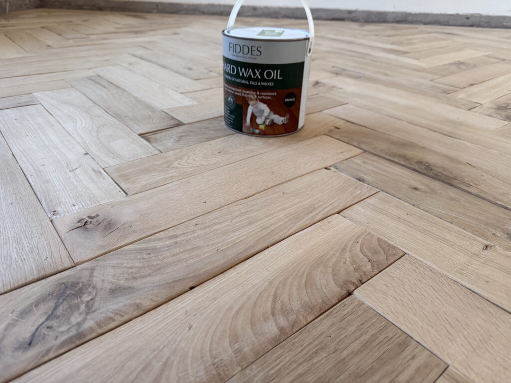 Fiddes hard wax oil can on wooden herringbone floor