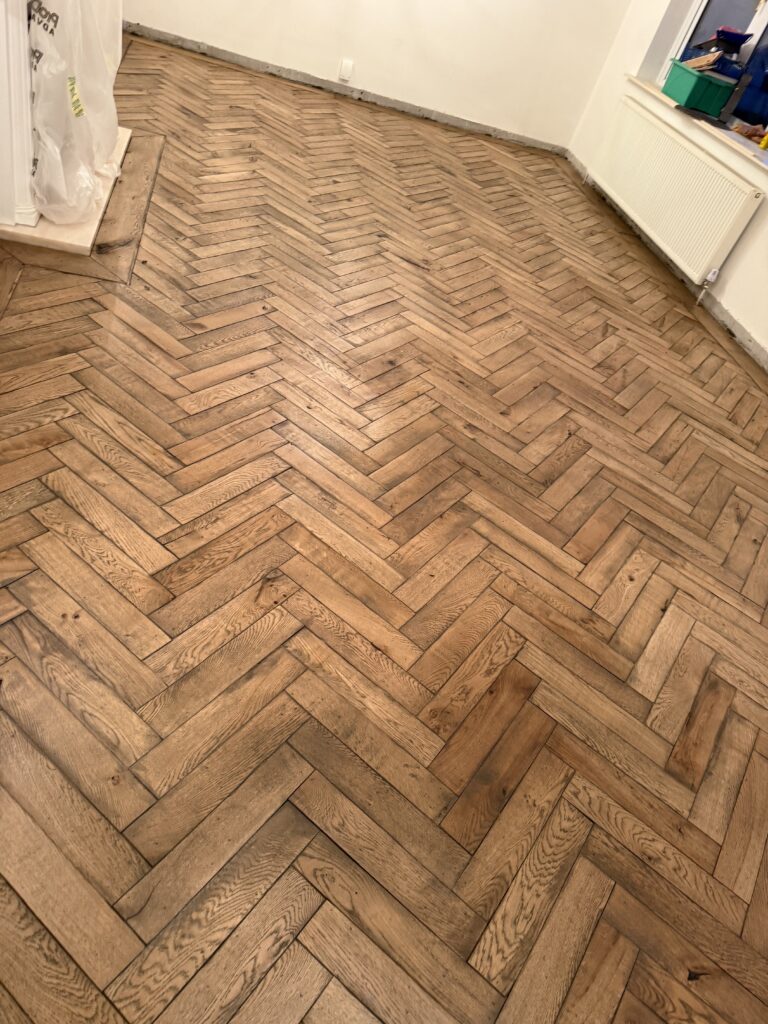 Wooden herringbone parquet flooring in residential room