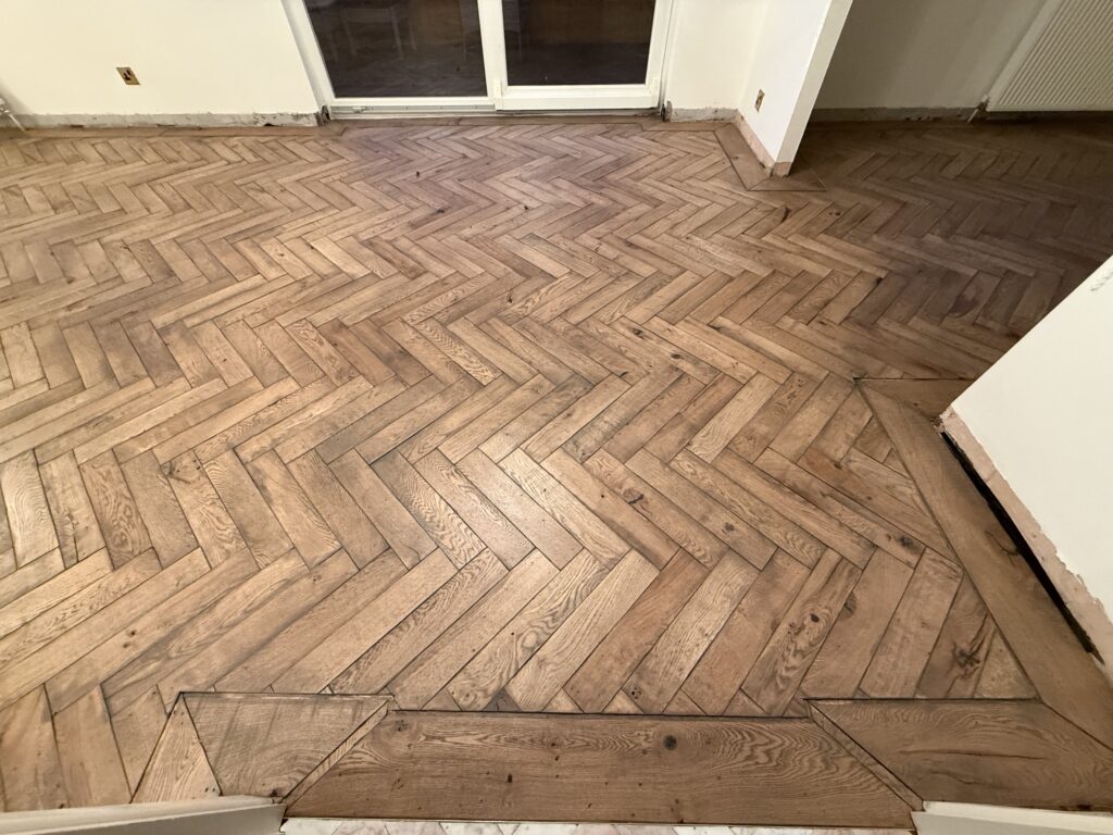 Herringbone pattern wood flooring in modern room