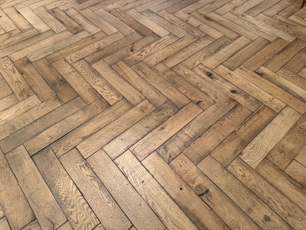 Herringbone pattern wooden floor with natural oak finish