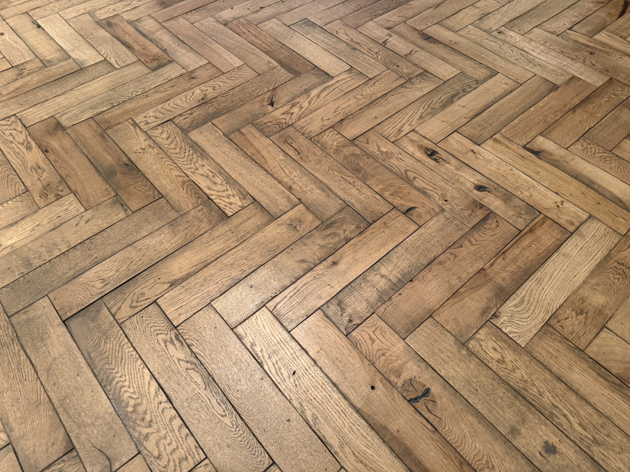 Herringbone pattern wooden floor with natural oak finish