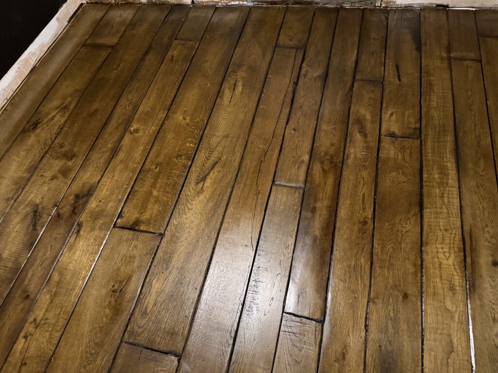 Wooden hardwood floor with diagonal plank pattern and natural finish