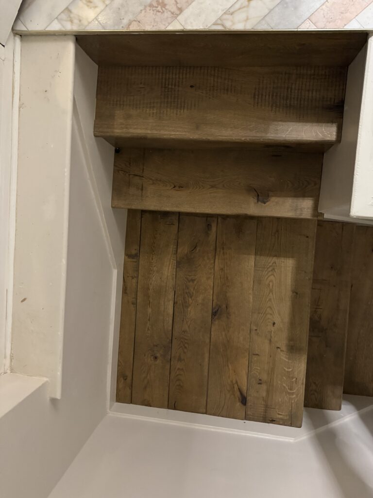 Empty wooden cabinet shelves with white frame interior