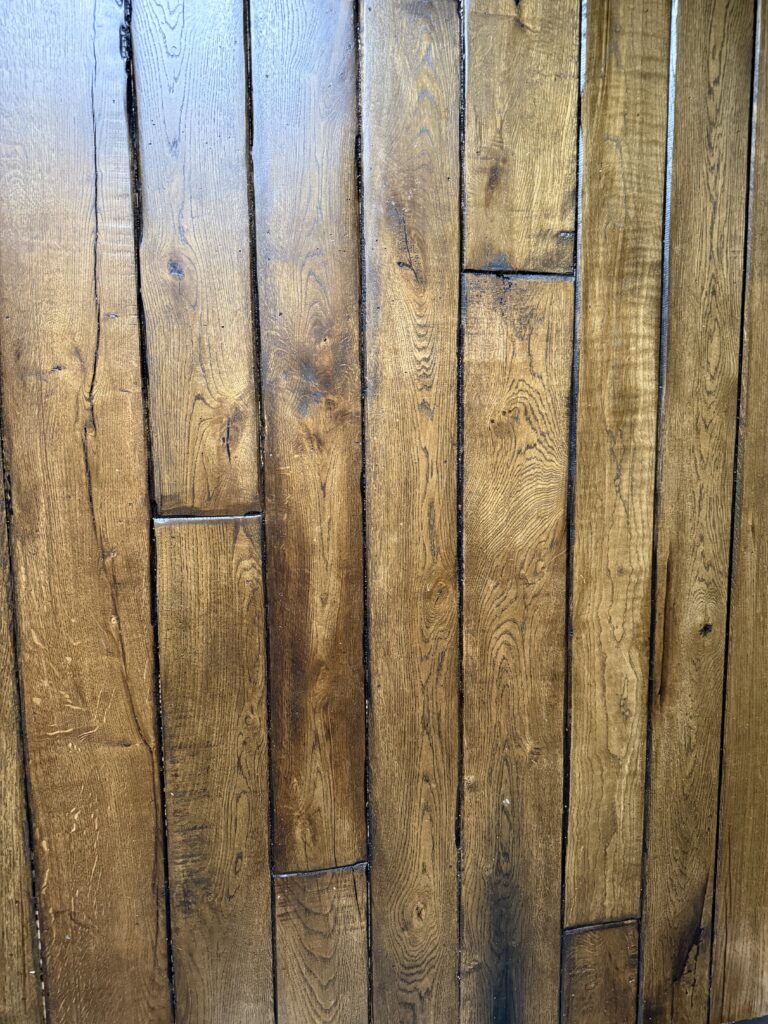 Wooden hardwood floor planks with varied grain patterns and finish
