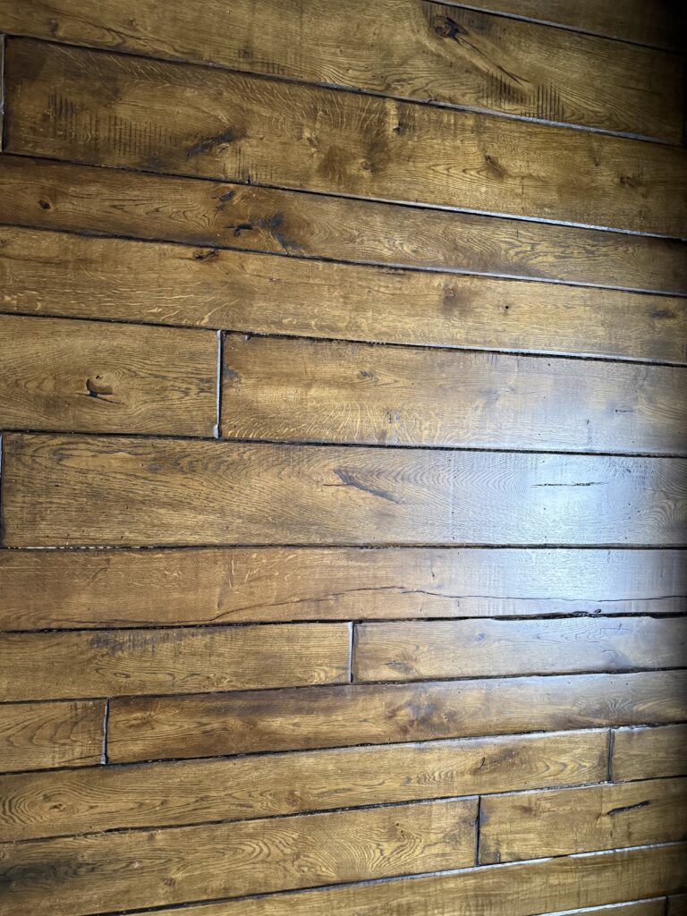 Hardwood floor with random width planks and natural grain patterns